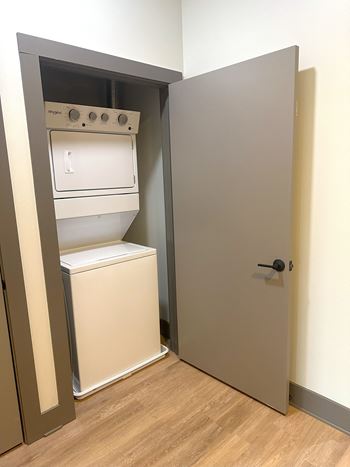 a room with a refrigerator and a door to a closet